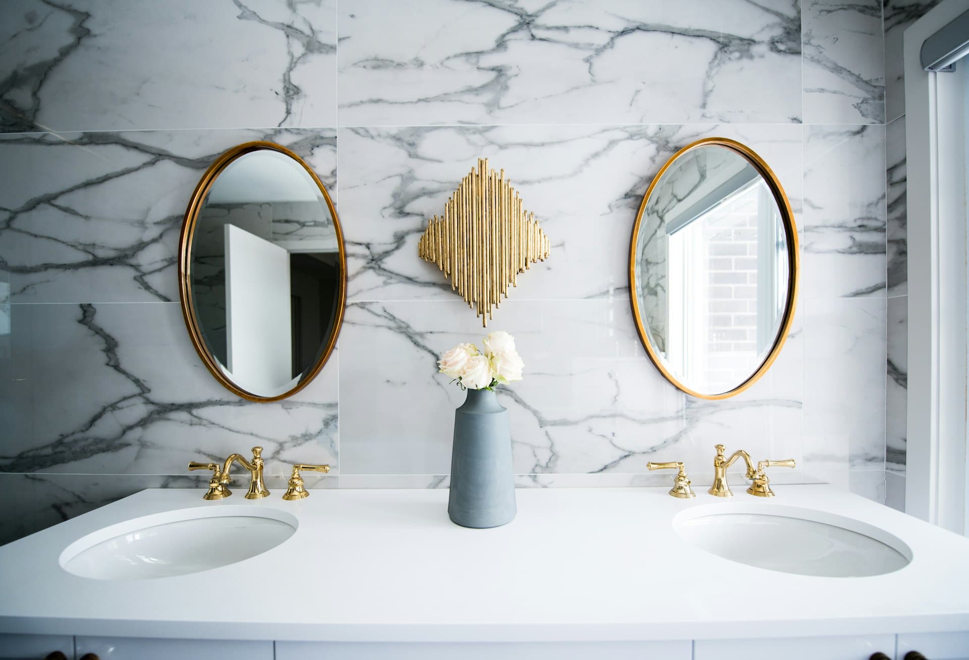 White marble-effect tiled bathroom with toilet, quadrant shower and dark wood-effect tiled floor