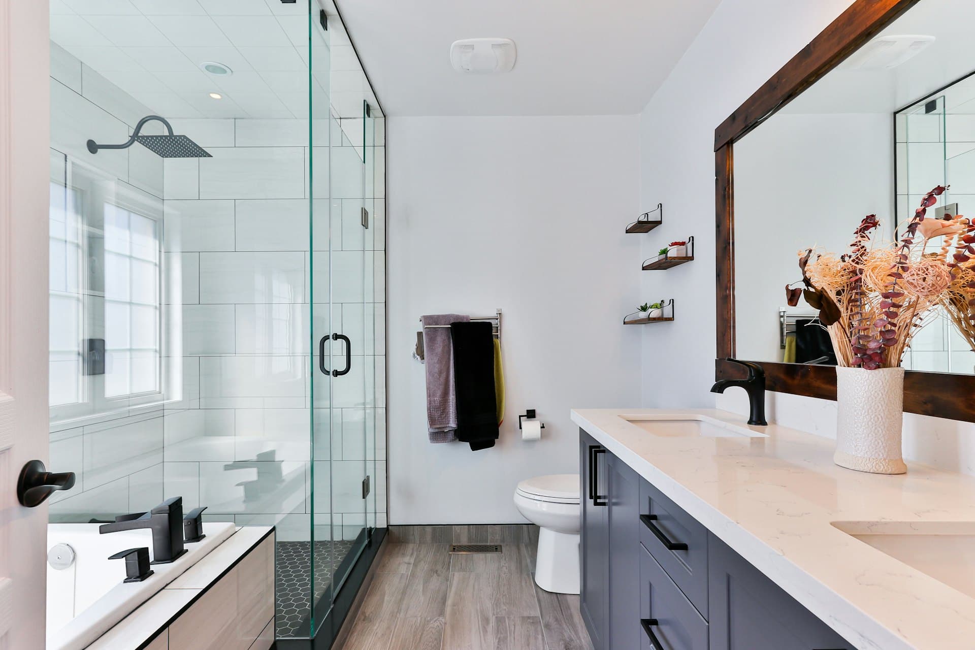 Bright white-tiled bathroom with a glass walk-in shower
